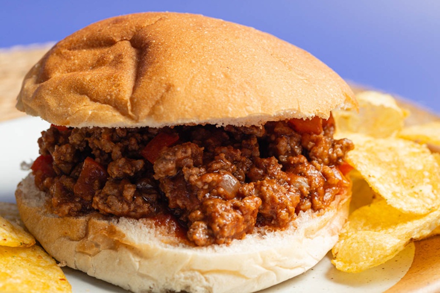 Crockpot Sloppy Joes Recipe a Sloppy Joe on a Plate with Chips