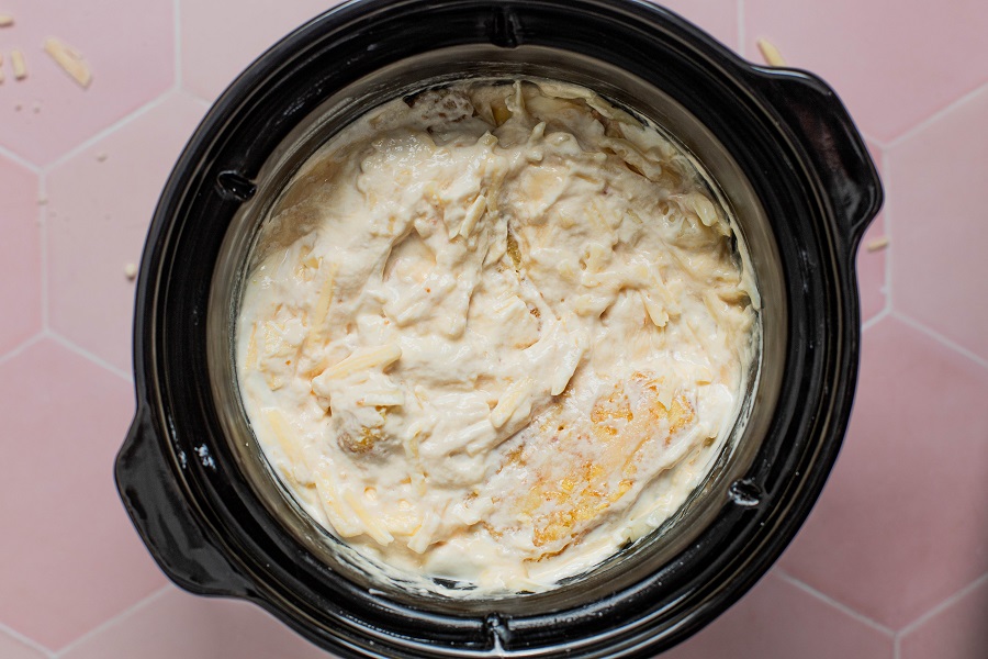 Cheesy Crockpot Hashbrown Potatoes Recipe All Ingredients Mixed into a Crockpot Except the Chips