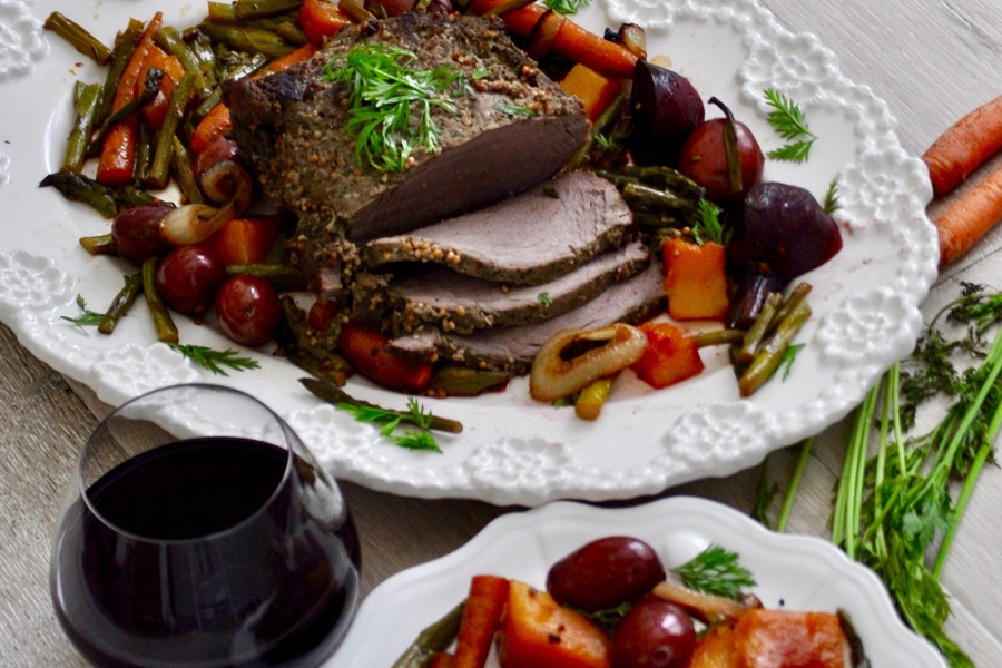 Crockpot Beef Pot Roast Recipe Cooked Roast on a Platter Sliced, and Surrounded by Roasted Veggies